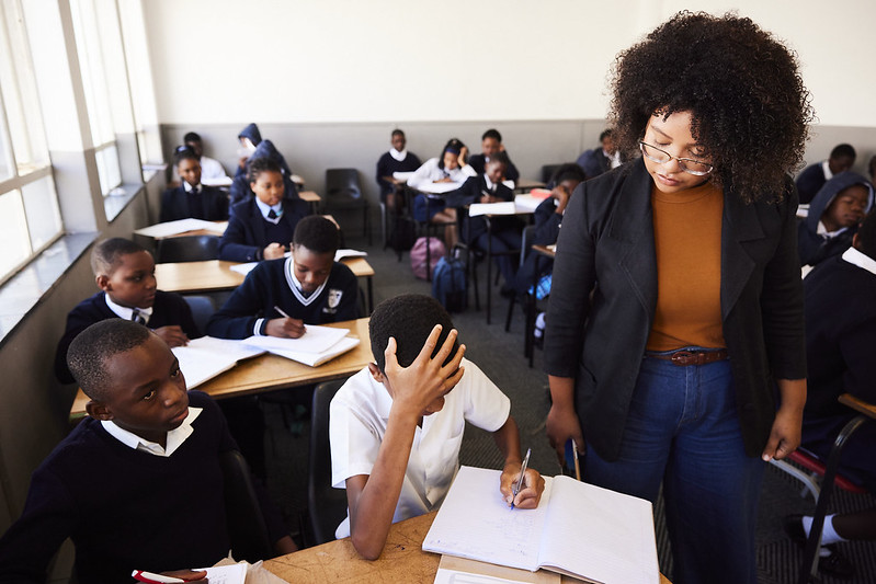 A Tilting Futures gap year program student tutoring students in South Africa