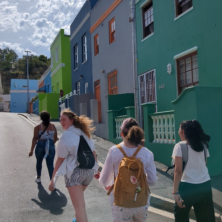 Tilting Futures gap year travel program students walking up the street next to bright and colorful houses