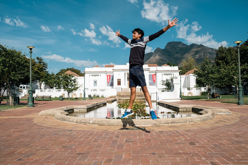 A Tilting Futures gap year travel program student jumping for joy