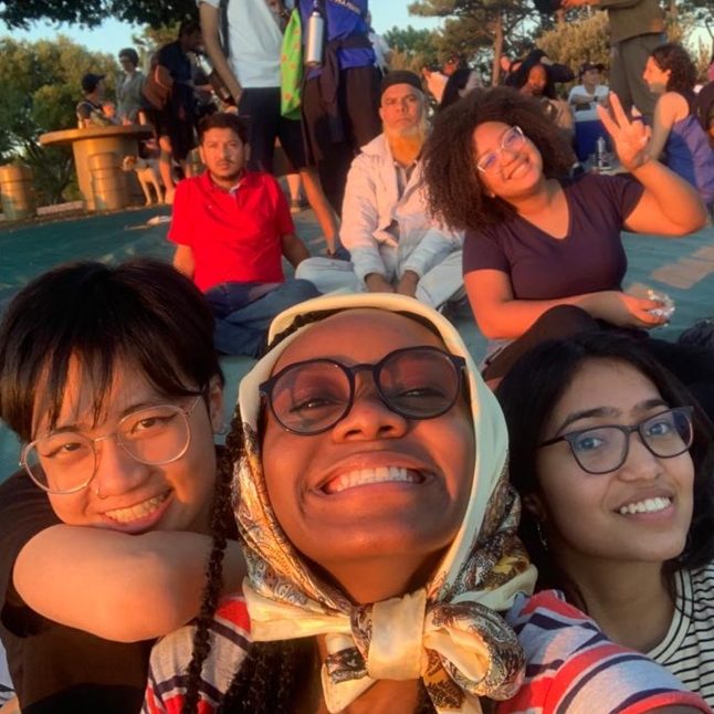 Several Tilting Futures gap year travel program students taking a happy selfie outside on the grass