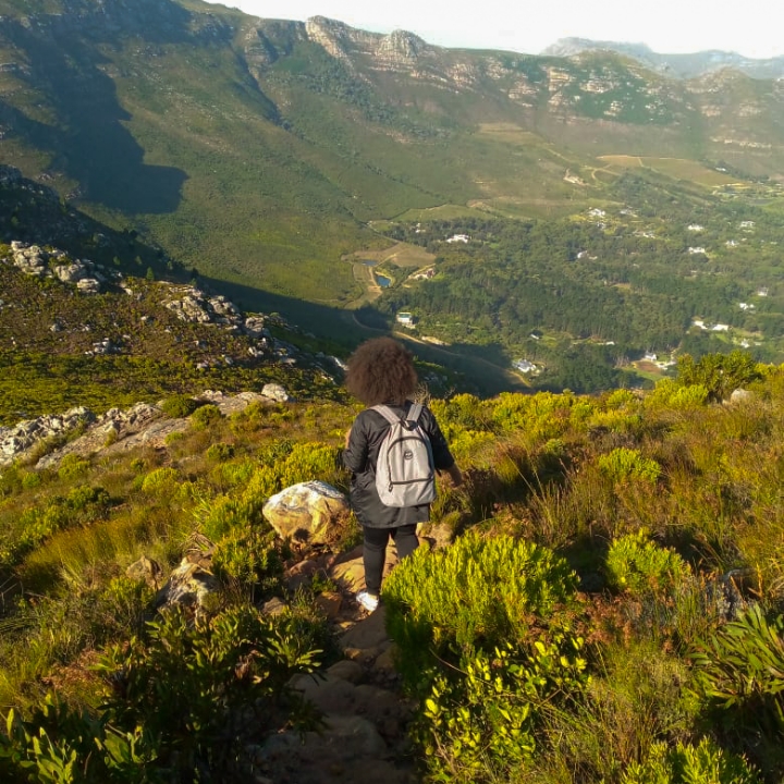 Karine Saraiva, a Tilting Futures gap year travel program student, hiking down a beautiful mountainside